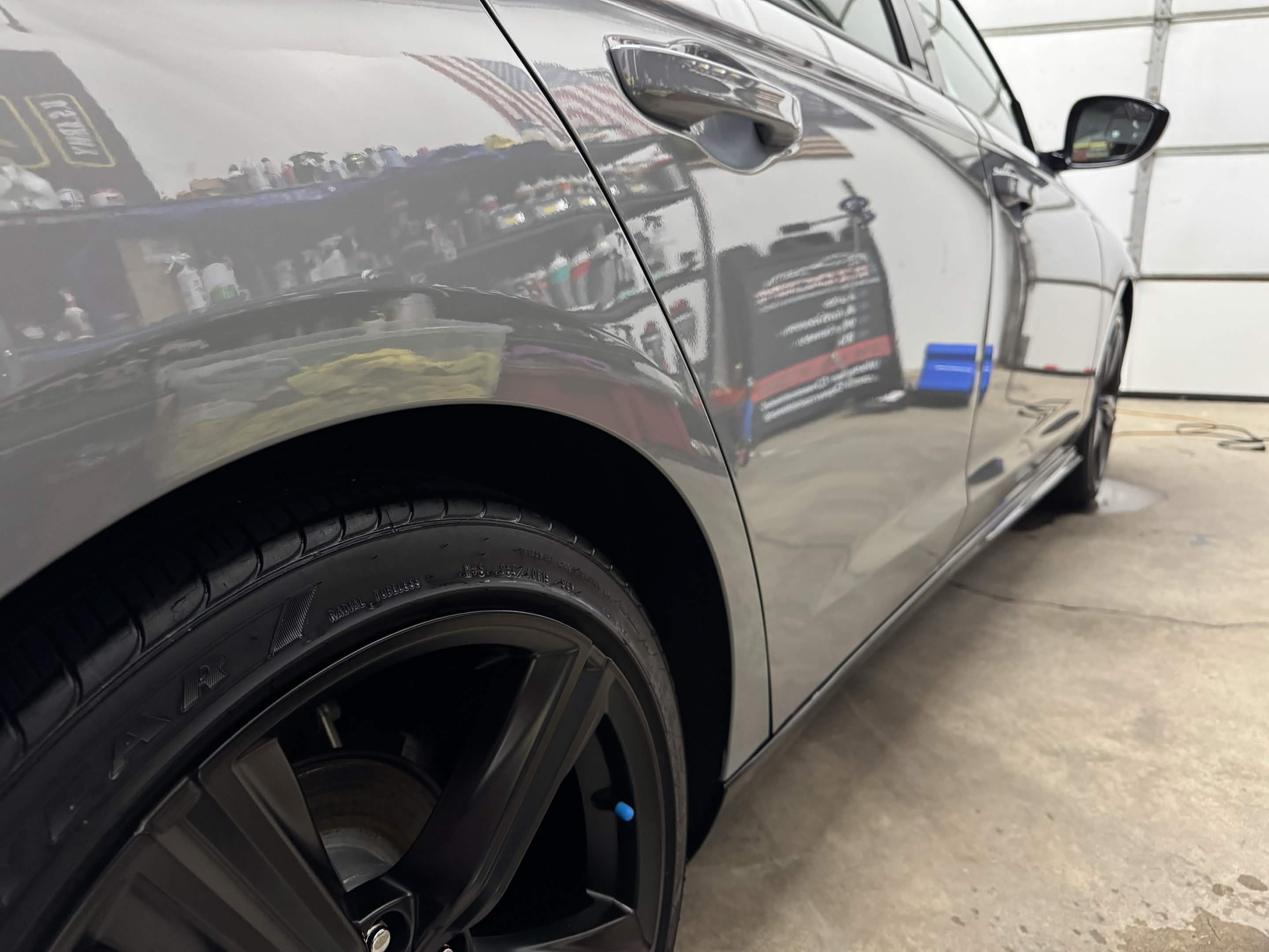 Glossy gray car paint after Cleveland auto detailing with sharp reflections and clean tire dressing