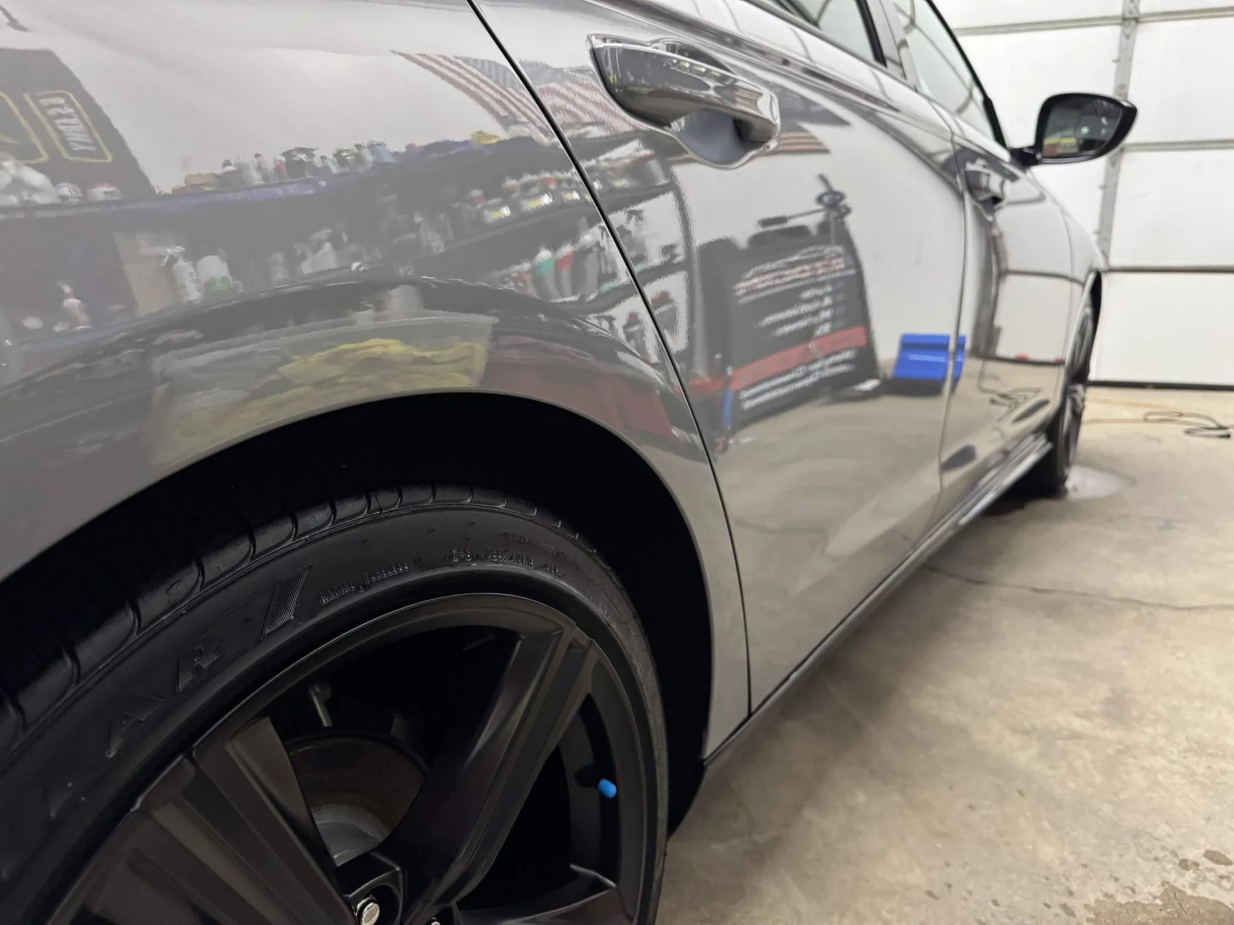 Glossy gray car paint after North Olmsted auto detailing with sharp reflections and clean tire dressing
