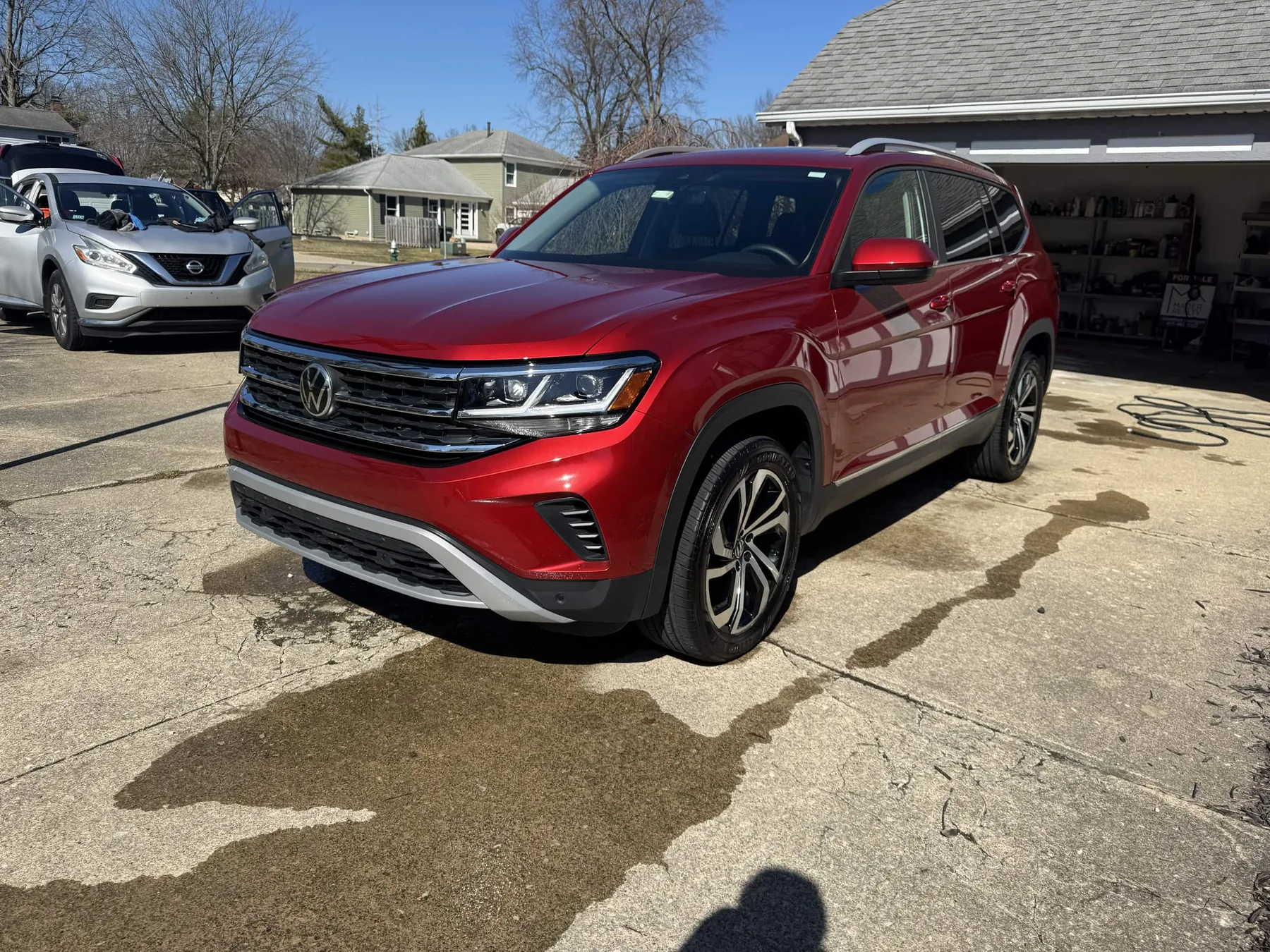 Red Volkswagen SUV after North Olmsted exterior detailing with clean paint, wheels, and tires